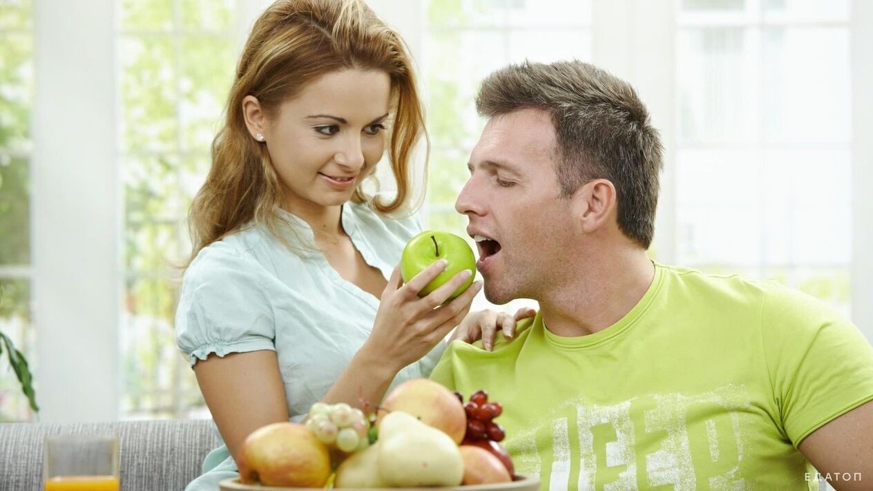 the girl feeds the man healthy food